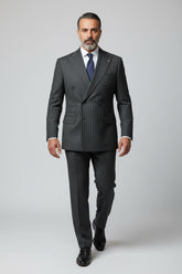 Man wearing green pinstripe double-breasted suit with tailored fit, ideal for formal occasions.